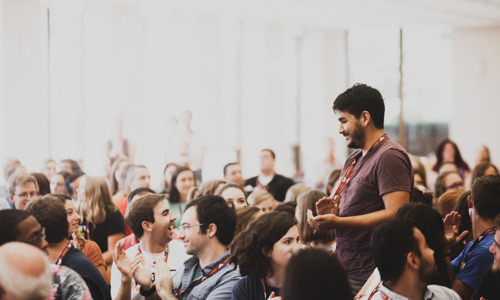 Jesuit Volunteers stand up at 2018 Orientation at Loyola University Chicago when their community house names are called out in celebration of the year ahead. (2018)