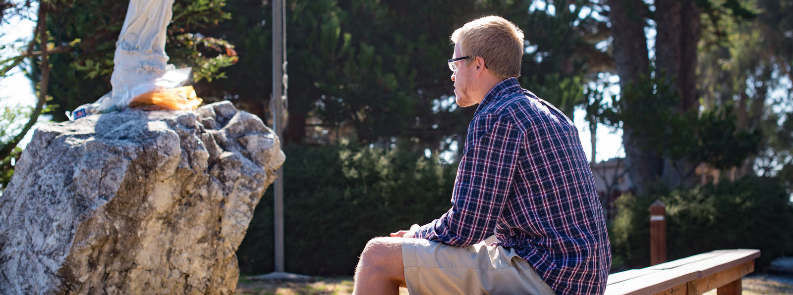 Spencer L (San Jose 2016-17) prays at orientation at camp st. francis