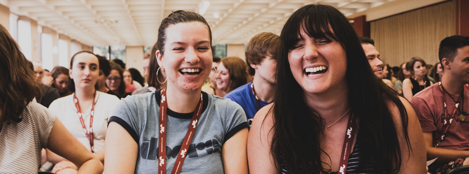 Jesuit Volunteers laugh while seated at Orientation 2018 in Chicago.