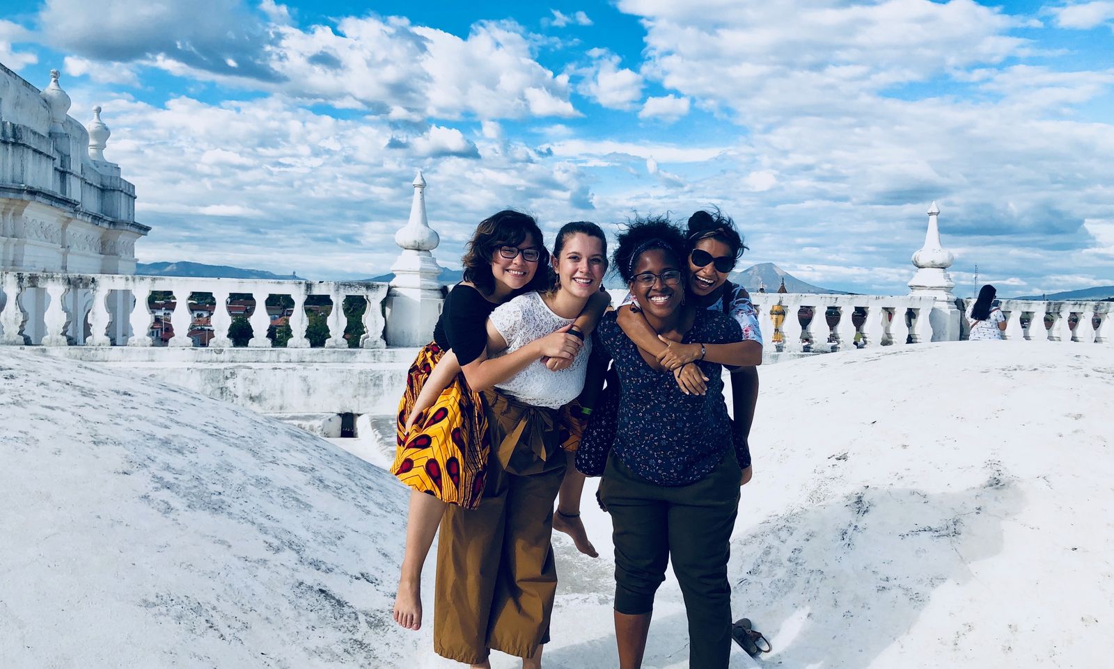 Managua, Nicaragua Jesuit Volunteers prior to JV community house closure in 2017 due to civil unrest in the country. JVC Nicaragua exploring the roof of Basilica de la Asunción in Leon. Pictured left to right is Glendys Orellana (2016-18), Rachel Schwarz (2017-19), Paola Joaquin Rosso (2017-19), and Luvy Martinez, a friend and coworker. Photograph taken by a passerby.